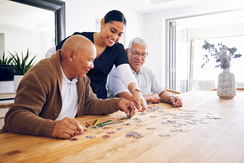care member and seniors enjoying a puzzle care member and seniors enjoying a puzzle